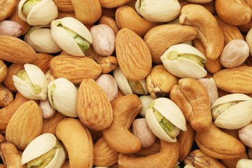 Mixed nuts background, almonds, pistachios, cashews and peanuts