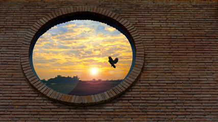 Fototapeta na wymiar Round window on brick wall surface.