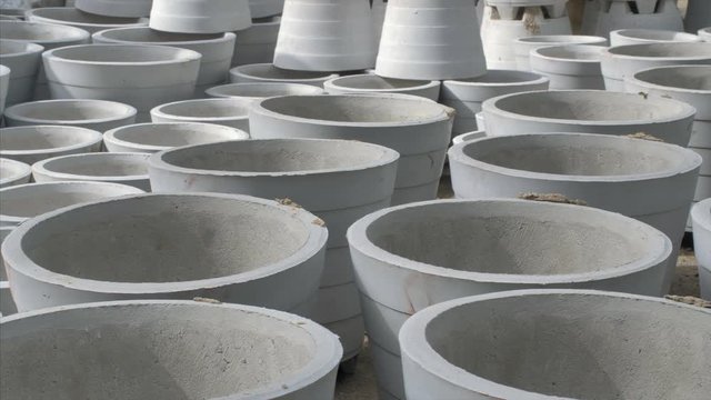 Pan shot of ready cement planters (Gamla) kept for selling. 