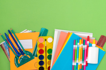 School supplies on a green background