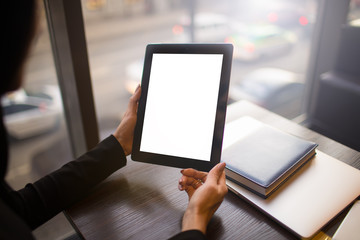 Closely business woman holding modern portable touch pad with empty mock up copy space screen background for promotional content, sitting at desktop in office. Digital gadget with blank display