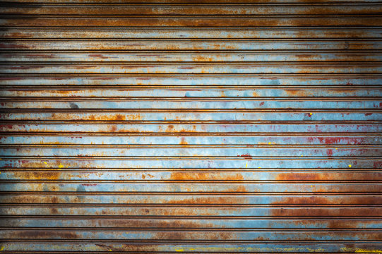 Old weathered and rusty steel door for steel metal backgroud and texture.