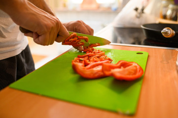 Man slicing vegetable  red peppers
