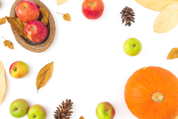 Autumn frame made of fall leaves, pine cones, apple and pumpkin on white background. Thanksgiving day comcept. Flat lay, top view