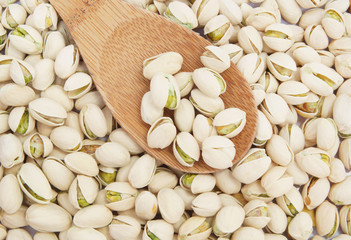 Pistachio nuts and wooden spoon