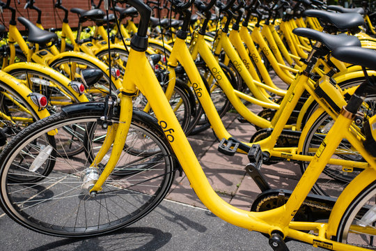 Pathum Thani, Thailand - April 27, 2018 : Ofo bikes are parked on the side of the road. Ofo is a bike-sharing service provider.