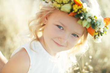 Little girl with flowers on her head. 