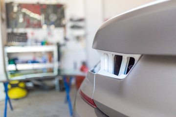 Car in garage prepared for repair.