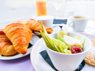 Breakfast with orange juice and fresh fruits on table