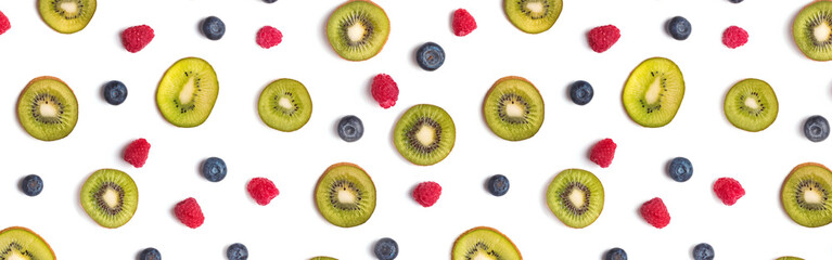 Creative fruit banner. Kiwis, blueberries and raspberries on the white background
