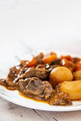 Beef meat stewed with potatoes-Traditional French cuisine Beef Bourguignon potatoes carrots in persillade