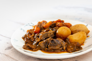 Beef meat stewed with potatoes-Traditional French cuisine Beef Bourguignon potatoes carrots in persillade