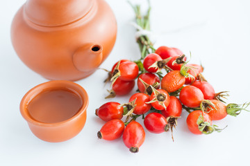 herbal tea with rose hips isolated on white, Medicinal plants and herbs composition