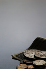 Shabby dollar bills and coins still life