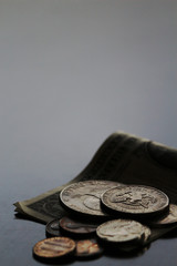 Shabby dollar bills and coins still life
