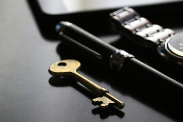 Still life of antique brass keys and cool male belongings