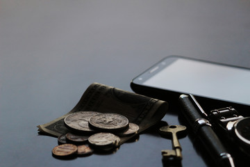Still life of male cool belongings with dollar bills and coins