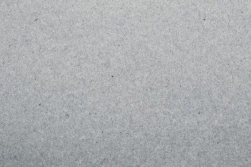 Kraft paper texture. Gray carton surface, rough material. Grey packaging background, dirty card backdrop. Vintage paper sheet pattern.
