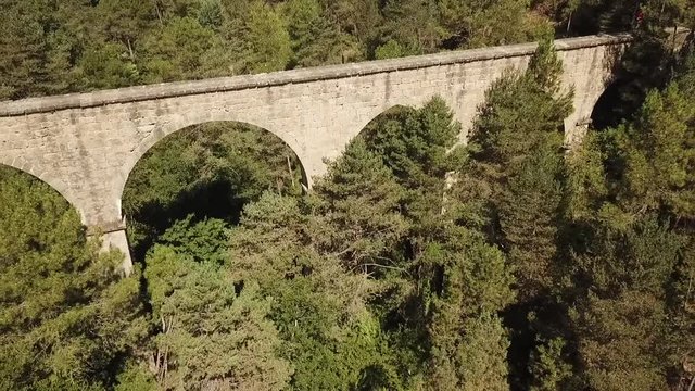 Aerial view of the Pont de la Frau aqueduct in Solsona, Catalonia, Spain, Europe.
Dolly pull back shot revealing the bridge.