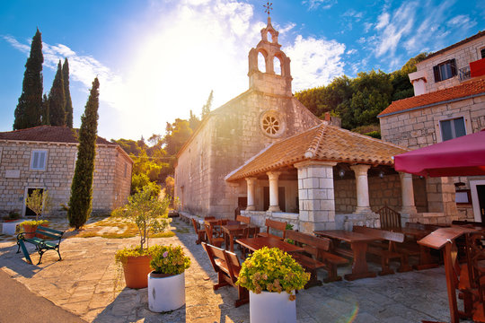 Idyllic coastal village of Racisce on Korcula island stone chapel sun haze view
