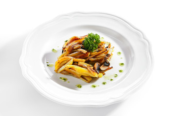 Fried Potatoes with Mushrooms on a Restaurant Plate Isolated