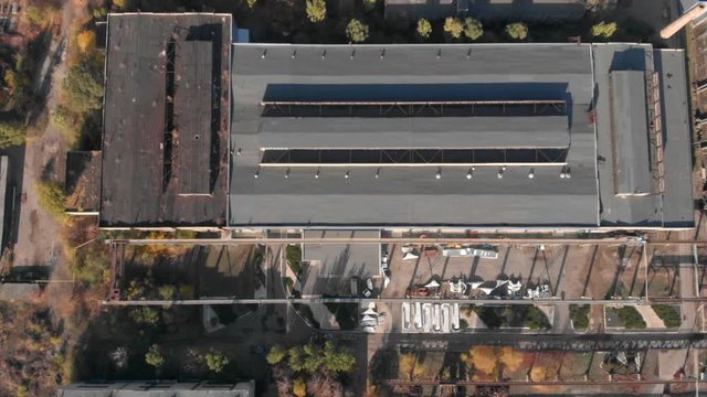 Old soviet factory plant big rusty hangar. Aerial footage, top view