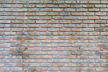 Background of old and dirty vintage orange dilapidated brick wall for background texture