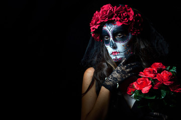 Portrait of woman dressed as catrina, skull to honor the dead in Mexico.