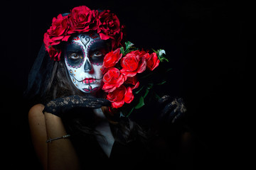 Portrait of woman dressed as catrina, skull to honor the dead in Mexico.