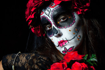 Portrait of woman dressed as catrina, skull to honor the dead in Mexico.