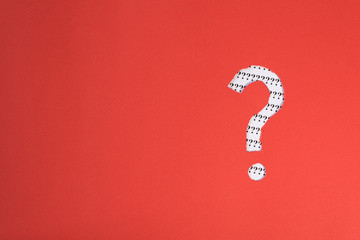 red paper teared to question mark symbol revealing more question mark on white paper. concept of...