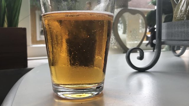 glas of beer in slowmotion
