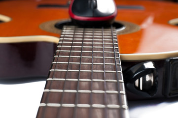 Computer mouse and guitar isolated on white background.