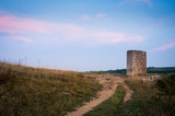 Old stone piece near a path with clouds in Burgenland