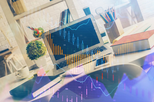 Financial graph colorful drawing and table with computer on background. Double exposure. Concept of international markets.