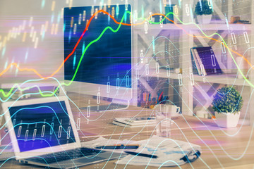 Financial graph colorful drawing and table with computer on background. Multi exposure. Concept of international markets.