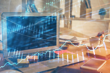 Financial graph colorful drawing and table with computer on background. Double exposure. Concept of international markets.