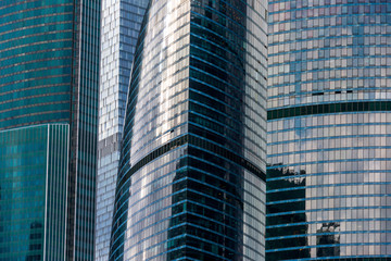Fototapeta na wymiar The glass facade of downtown Skyscrapers gleams in the sun.
