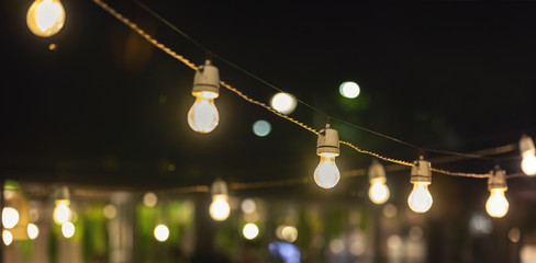 party string lights hanging over outdoor restaurant terrace