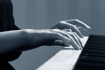 Young woman playing piano