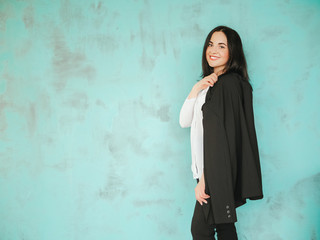 Fototapeta premium Portrait young beautiful girl in formal dark suit in office. Successful woman concept. Confident beautiful business woman being ready to work. Dress code. Corporation worker