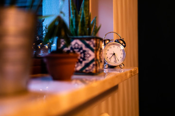 Alarm clock on window pane in bedroom