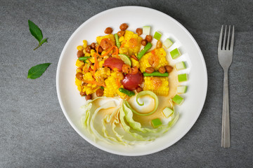 Fruit spicy salad in white dish on concrete table.