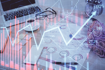 Forex market chart hologram and personal computer background. Multi exposure. Concept of investment.