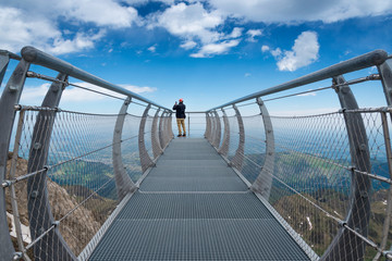 An imposing viewpoint on a walkway looks out in the air at bigorre's Pic du Midi in the Pyrenees Mountains (France).