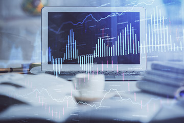 Financial chart drawing and table with computer on background. Multi exposure. Concept of international markets.