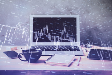 Double exposure of graph and financial info and work space with computer background. Concept of international online trading.
