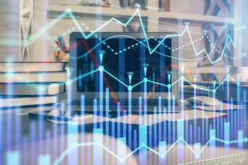 Financial graph colorful drawing and table with computer on background. Double exposure. Concept of international markets.
