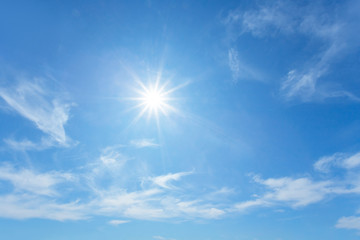 Naklejka na ściany i meble sparkle sun on a blue cloudy sky, outdoor background