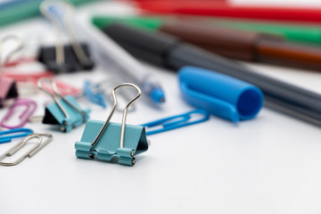 Colorful office tools set, pen, binder, paper clip, pencils, eraser isolated on white background